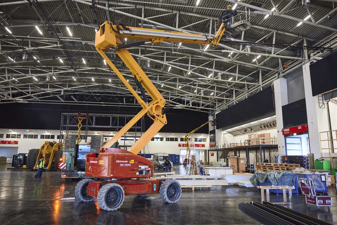 Access equipment is used to help prepare the exhibitor stands.