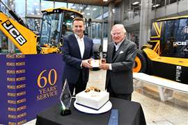Anthony Bamford, front right, receives his 60-year long service award from JCB CEO Graeme Macdonald at a presentation attended by JCB Directors.