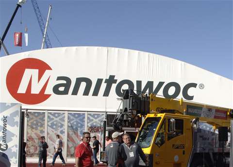 Red, black and white Manitowoc logo on a booth building with people in front