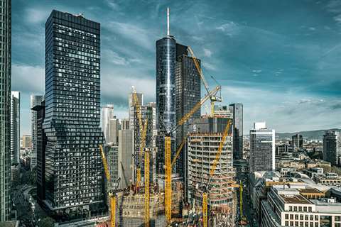 Liebherr tower cranes at work on a high-rise construction project.
